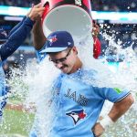 Toronto Blue Jays' Davis Schneider celebrating as teammates pour water on him after win over Los Angeles Dodgers