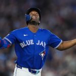 Blue Jays outfielder Jesús Sánchez celebrates with hands up after hitting a grand slam at Rogers Centre