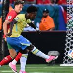 Brazilian player shoots at goal as Moroccan defender attempts to block during World Cup match