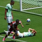 Qatar soccer player celebrates a stoppage time header goal as Switzerland goalkeeper stays on the ground disappointed