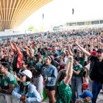 Football fans packed in an amphitheatre cheering and watching the World Cup kickoff in Vancouver